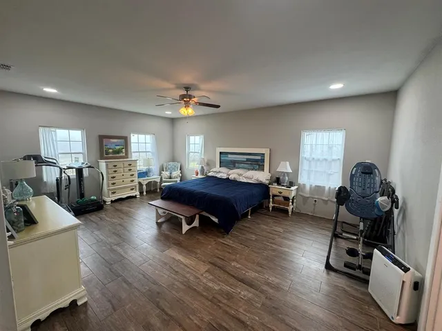 a bedroom with furniture and a wooden floor