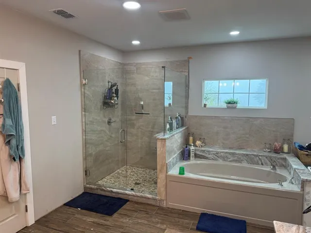 a bathroom with a bathtub and a shower