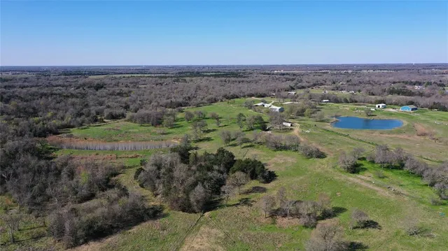 an aerial view of a houses with outdoor space