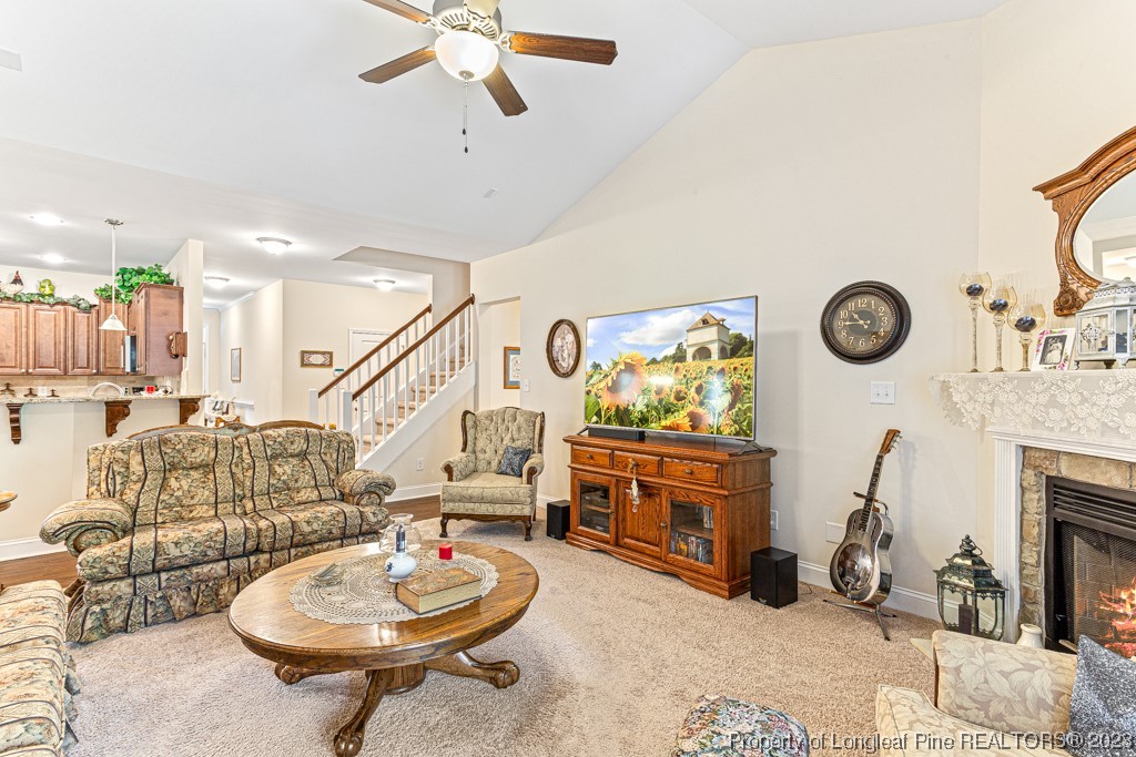 4532 Niagara Carthage Road Carthage, NC 28327 - Photo 15 of 44 a living room with furniture a fireplace and a chandelier