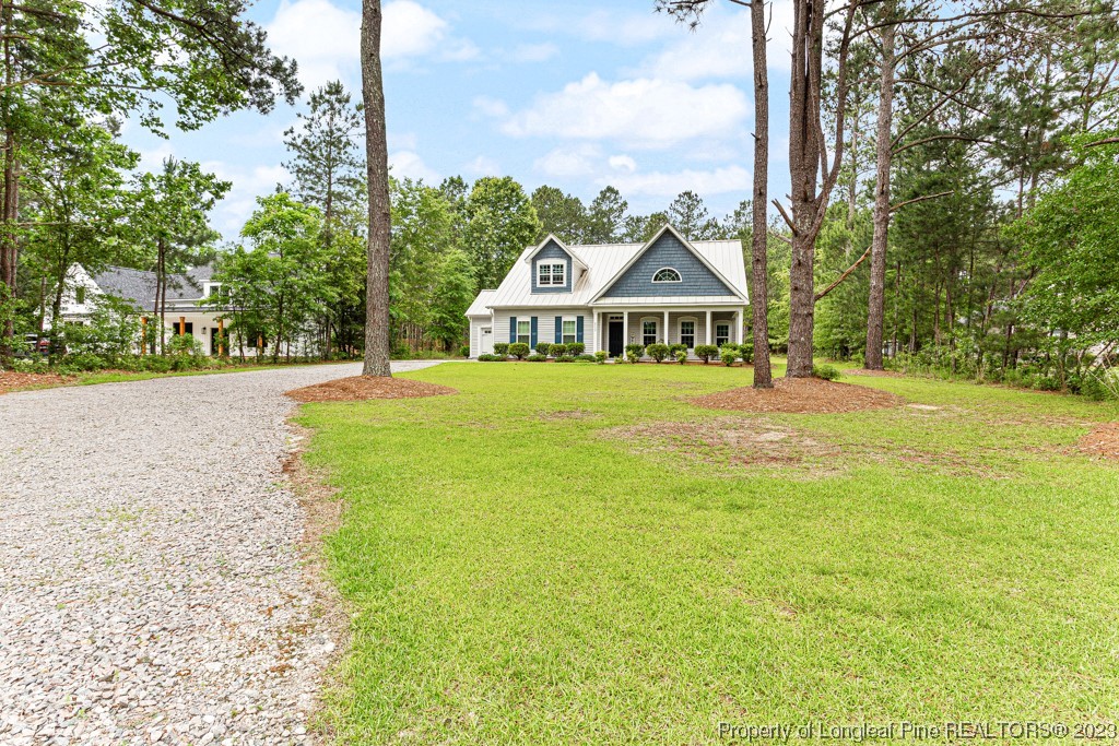 4532 Niagara Carthage Road Carthage, NC 28327 - Photo 2 of 44 a front view of a house with a yard and trees
