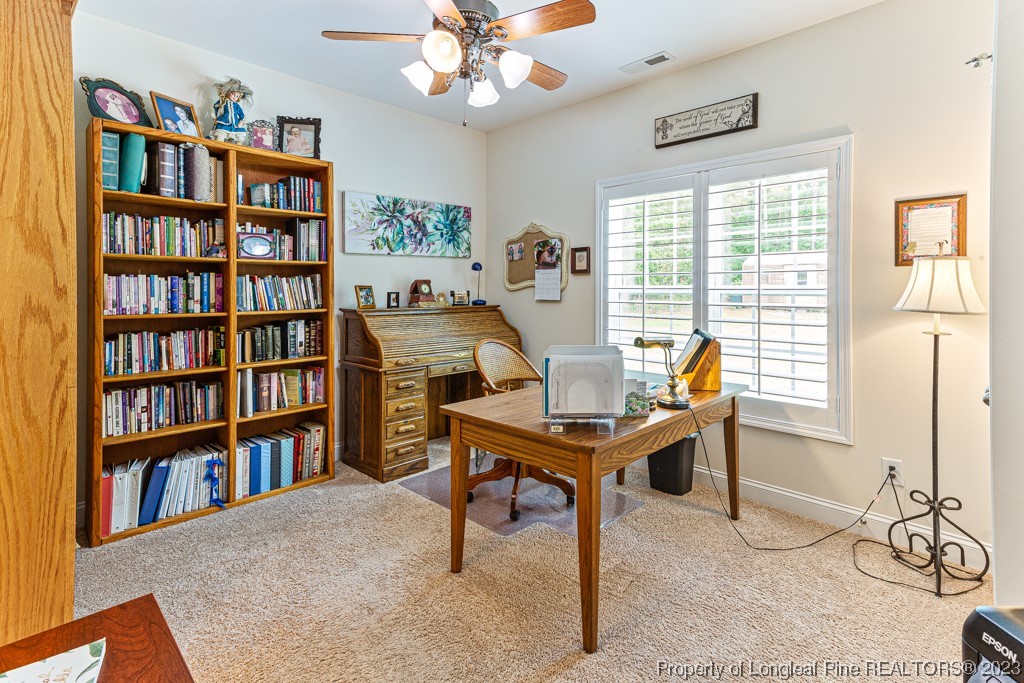 4532 Niagara Carthage Road Carthage, NC 28327 - Photo 21 of 44 a view of a workspace with furniture and a bookshelf