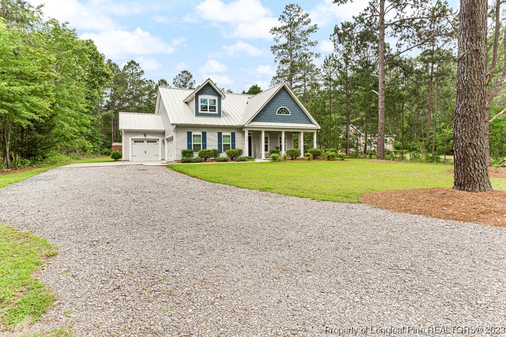 4532 Niagara Carthage Road Carthage, NC 28327 - Photo 3 of 44 a front view of a house with a yard and garage