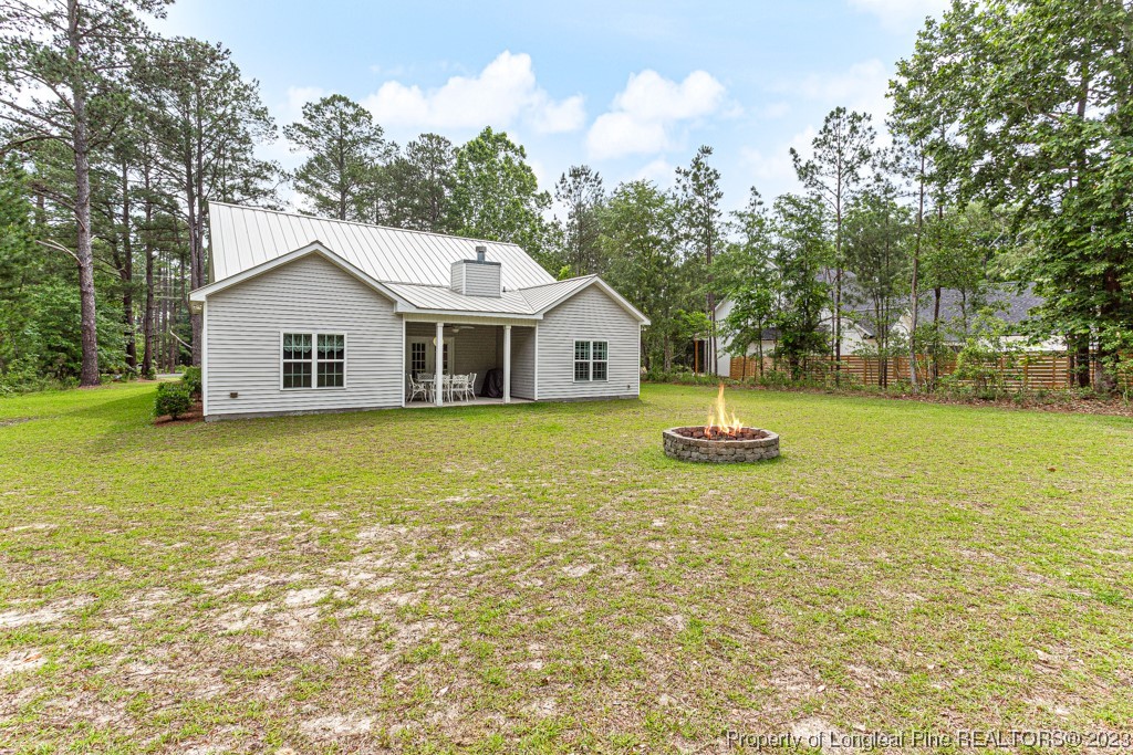 4532 Niagara Carthage Road Carthage, NC 28327 - Photo 39 of 44 a house view with swimming pool and trees in the background
