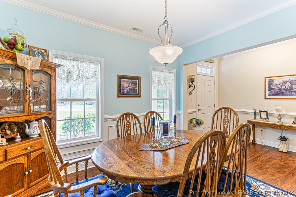 4532 Niagara Carthage Road Carthage, NC 28327 - Photo 8 of 44 a dining room with furniture a chandelier and wooden floor