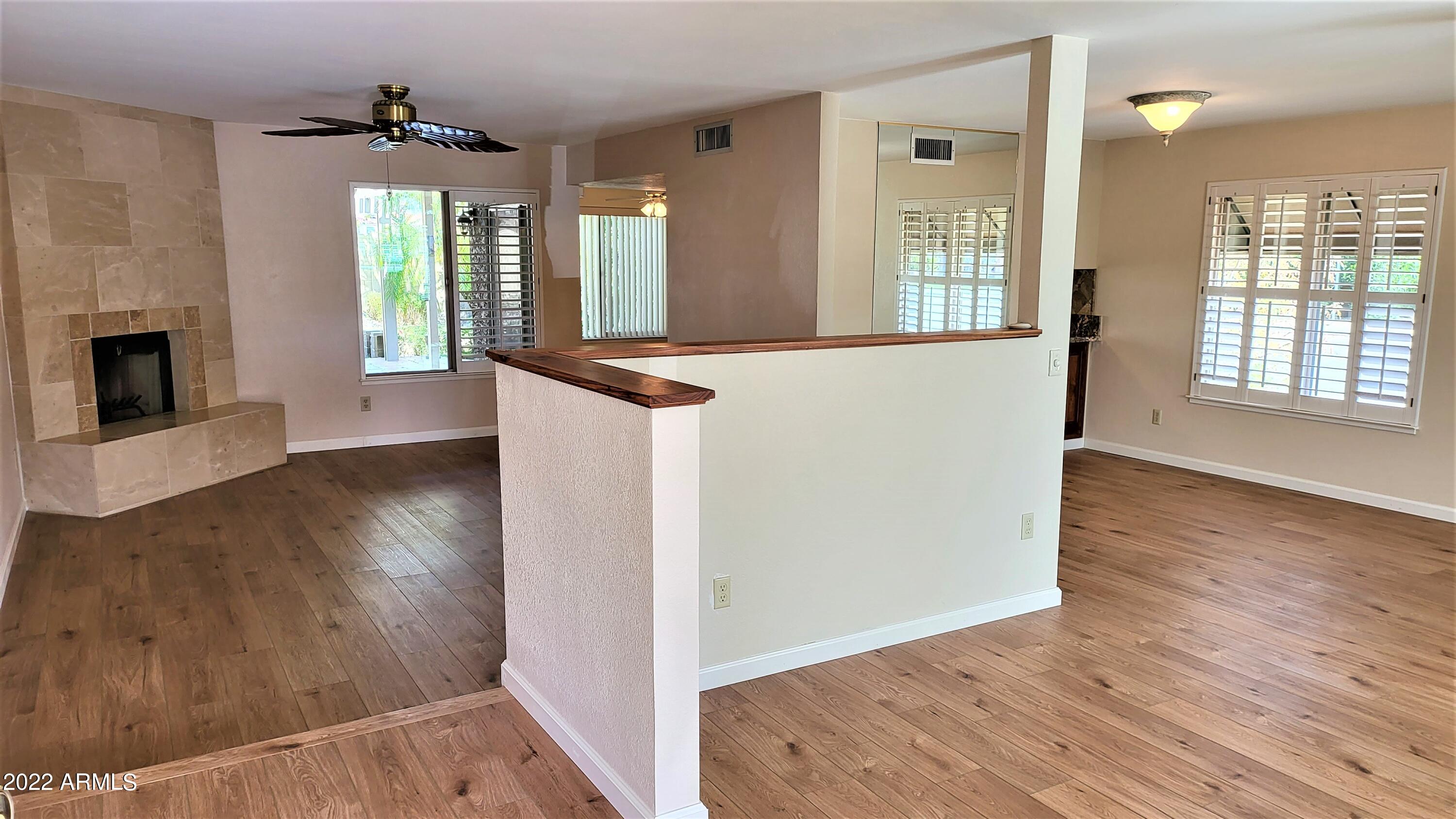 1940 East Hearn Road Phoenix, AZ 85022 - Photo 11 of 51 an entryway with wooden floor fireplace and windows