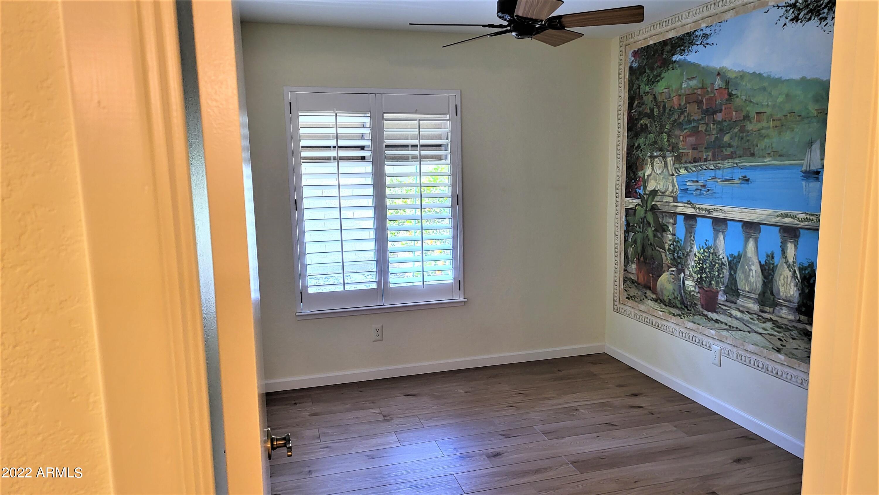 1940 East Hearn Road Phoenix, AZ 85022 - Photo 28 of 51 a view of a room with a window and wooden floor