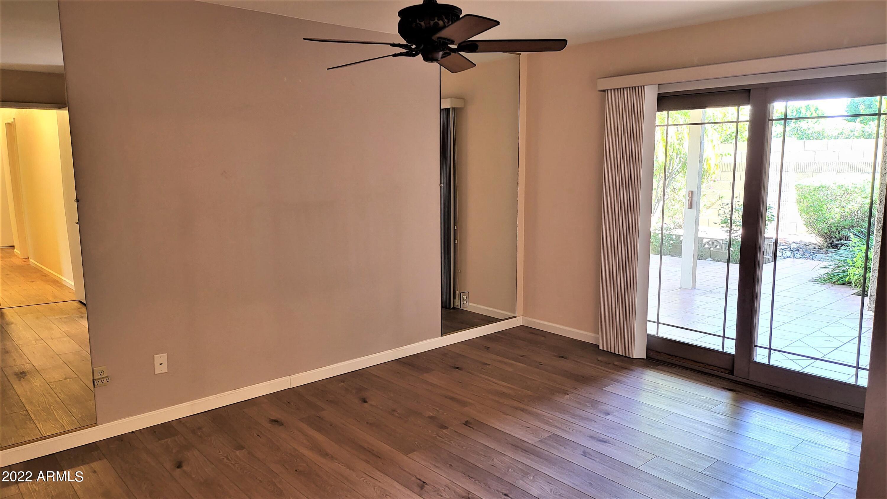 1940 East Hearn Road Phoenix, AZ 85022 - Photo 31 of 51 a view of room with window and hardwood floor
