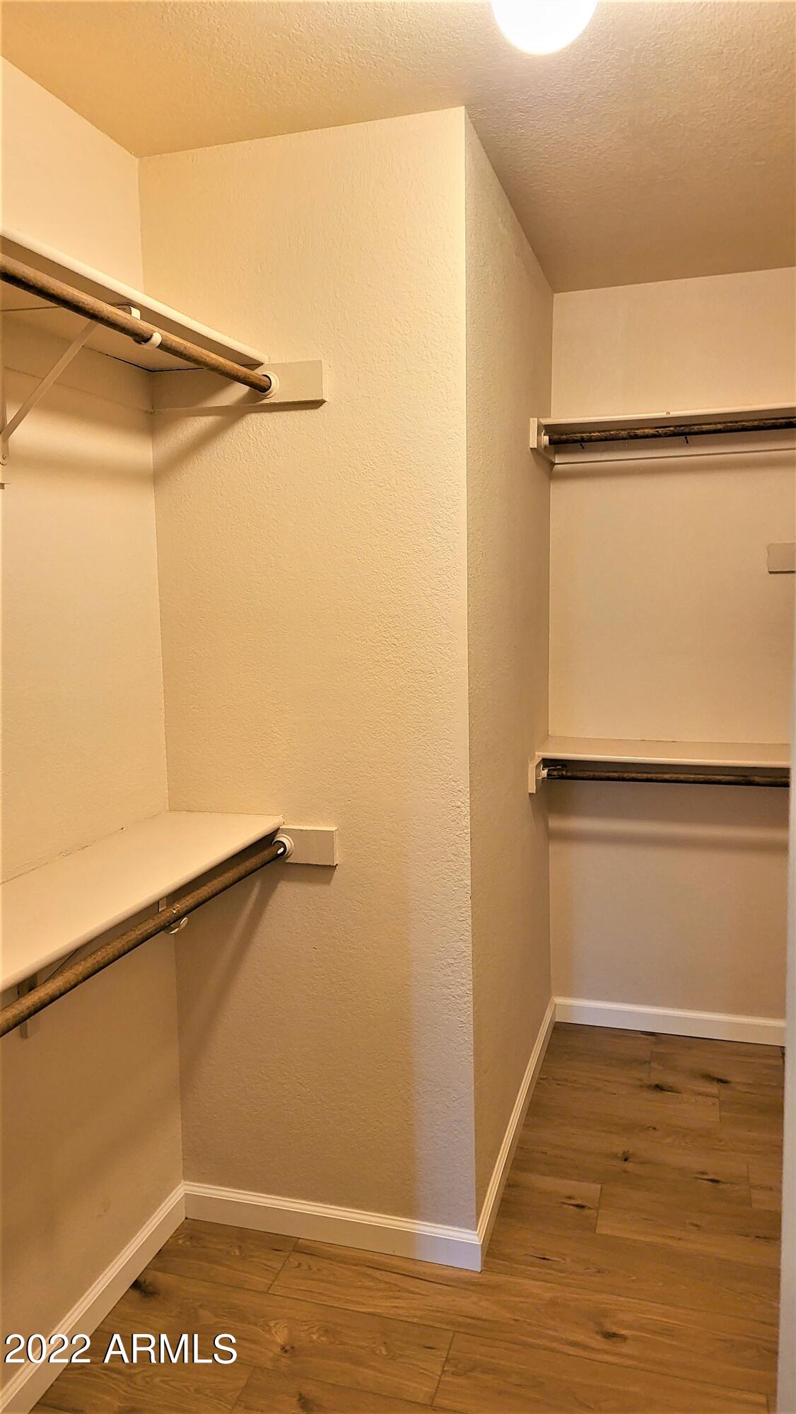 1940 East Hearn Road Phoenix, AZ 85022 - Photo 36 of 51 a view of walk in closet with empty racks