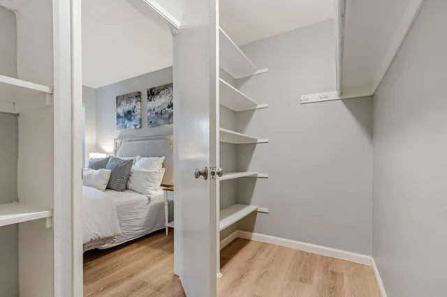 a view of a livingroom with wooden floor and a window