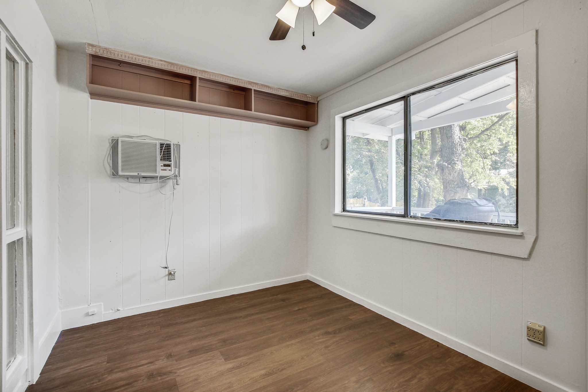 704 Franklin Boulevard, Unit A Austin, TX 78751 - Photo 12 of 32 a view of empty room with wooden floor and fan