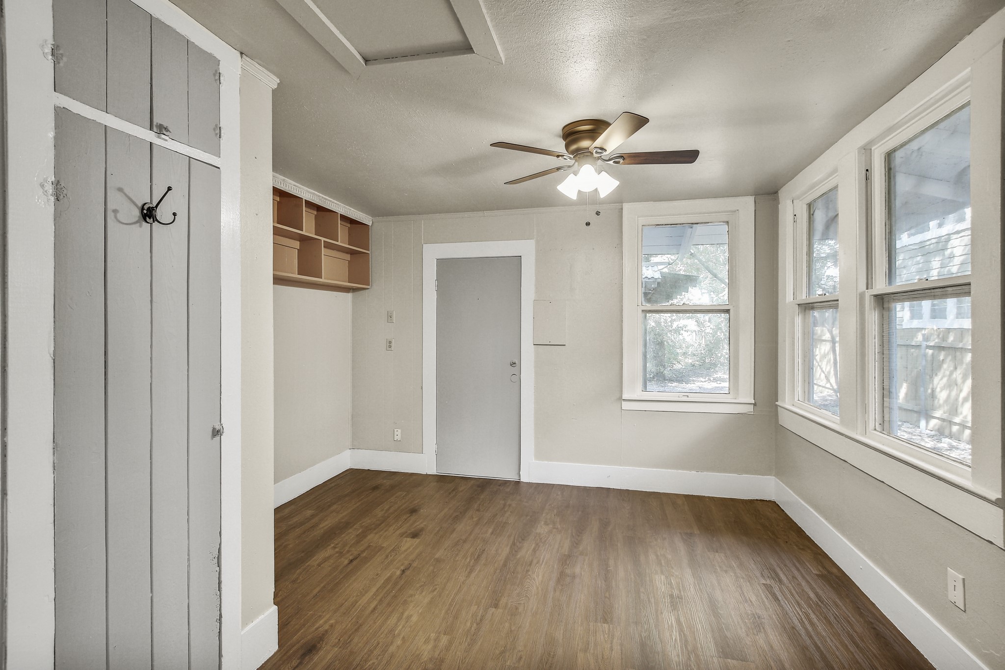 704 Franklin Boulevard, Unit A Austin, TX 78751 - Photo 13 of 32 a view of an empty room with a window and wooden floor