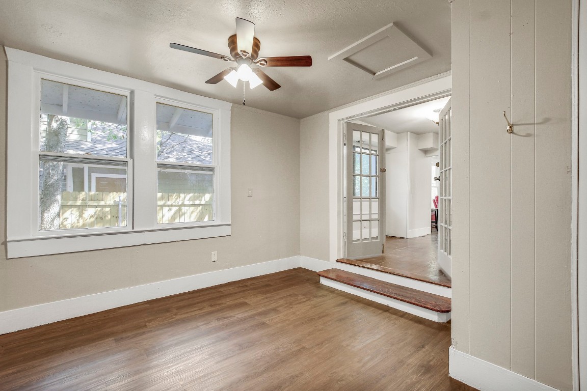 704 Franklin Boulevard, Unit A Austin, TX 78751 - Photo 14 of 32 an empty room with wooden floor and windows