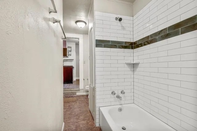 a bathroom with a bathtub and shower