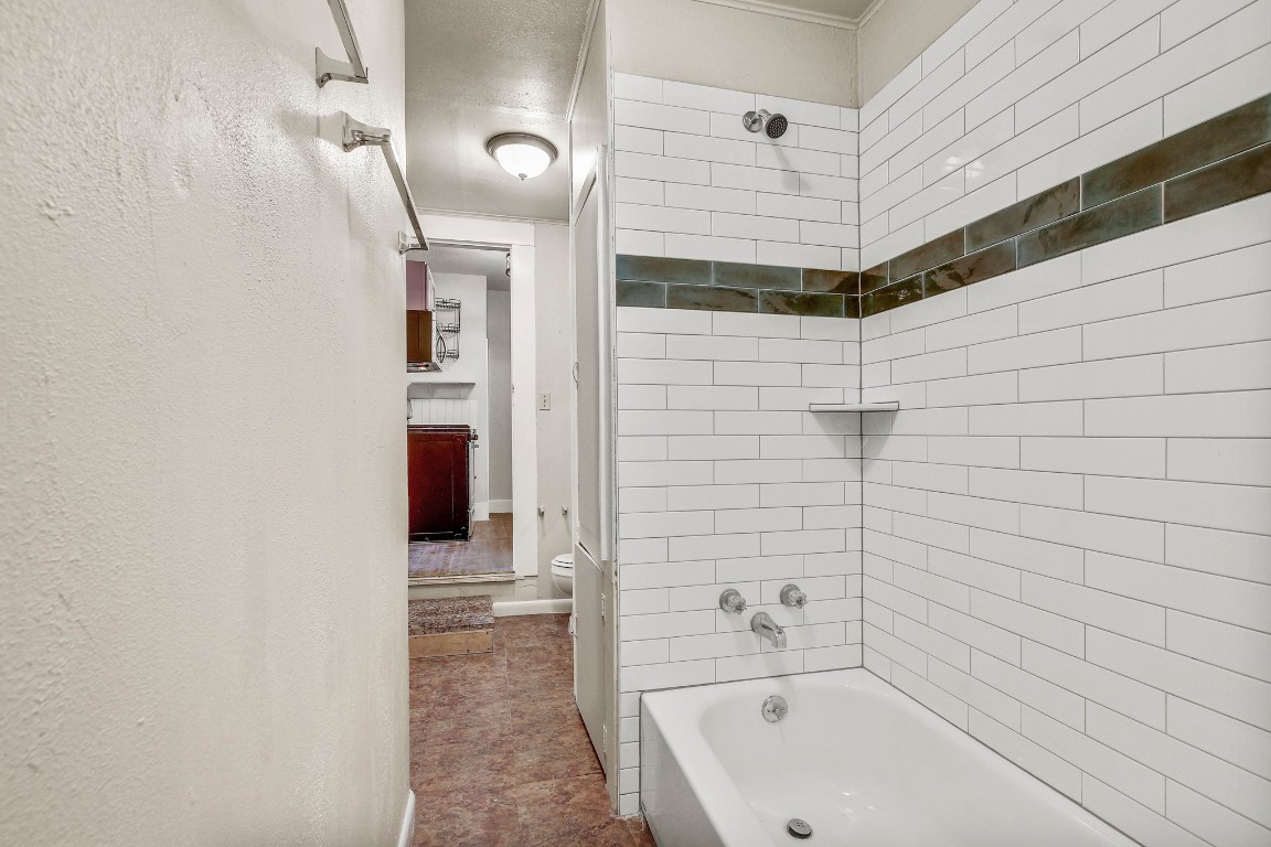 704 Franklin Boulevard, Unit A Austin, TX 78751 - Photo 17 of 32 a bathroom with a bathtub and shower