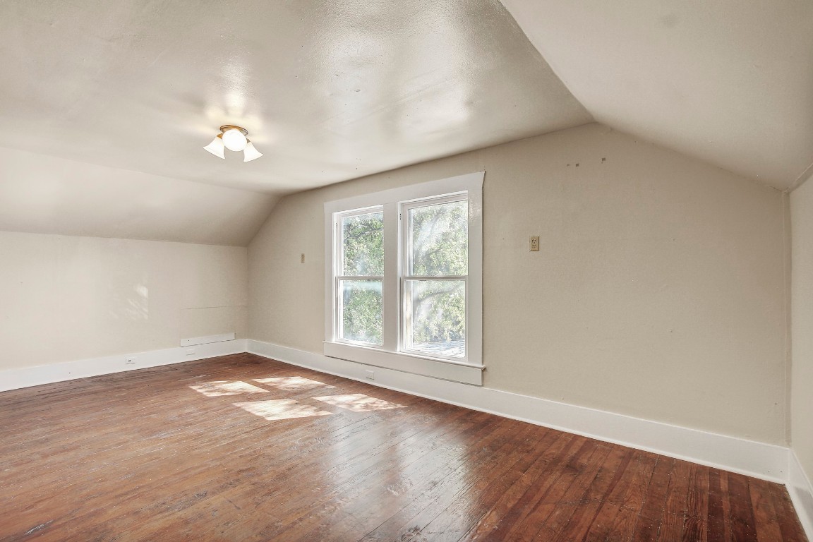 704 Franklin Boulevard, Unit A Austin, TX 78751 - Photo 20 of 32 an empty room with wooden floor and windows