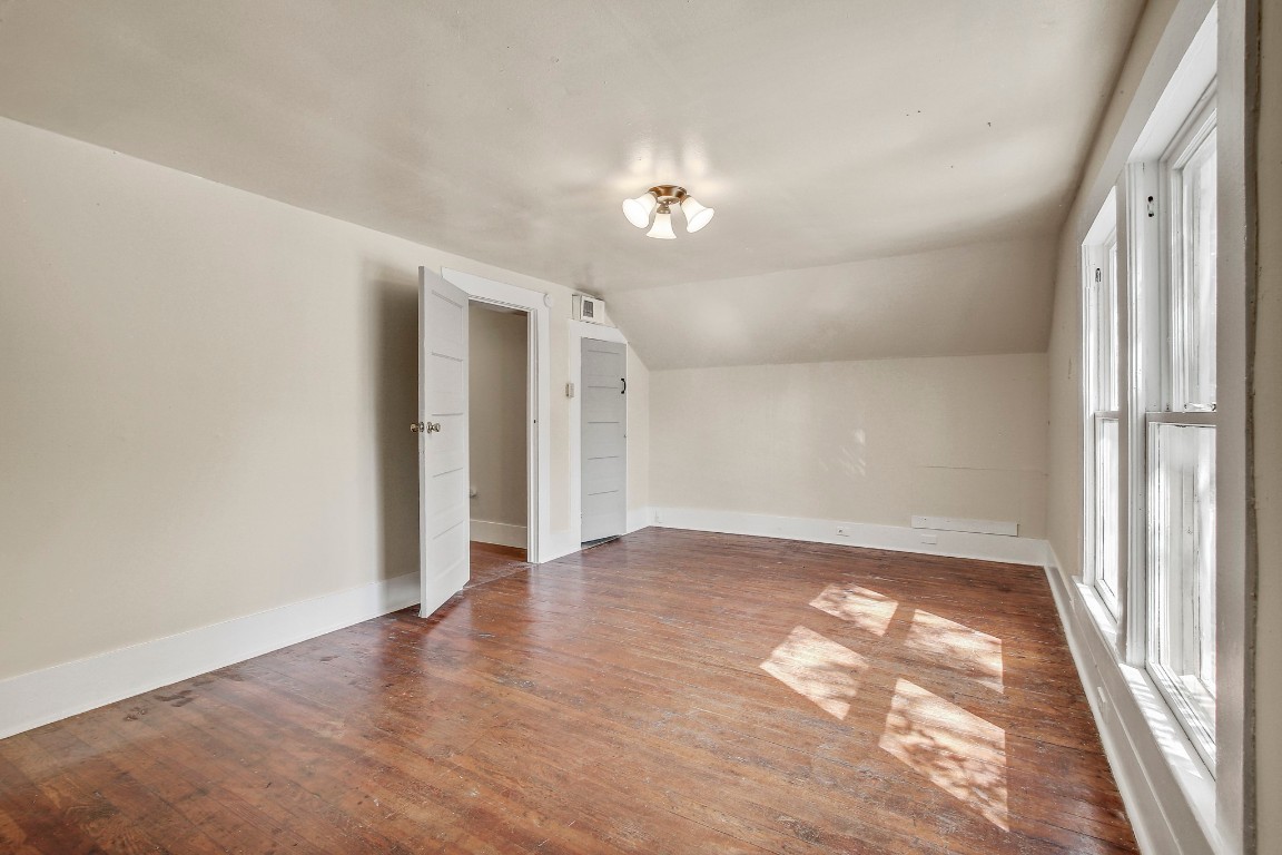704 Franklin Boulevard, Unit A Austin, TX 78751 - Photo 21 of 32 an empty room with wooden floor and a window