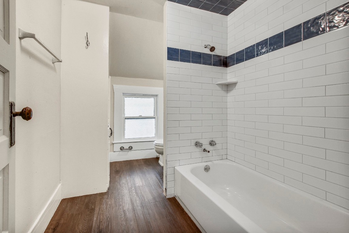 704 Franklin Boulevard, Unit A Austin, TX 78751 - Photo 23 of 32 a bathroom with a tub shower and vanity