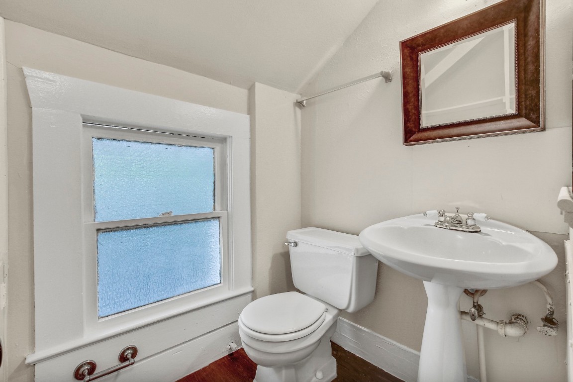 704 Franklin Boulevard, Unit A Austin, TX 78751 - Photo 24 of 32 a bathroom with a toilet sink and mirror