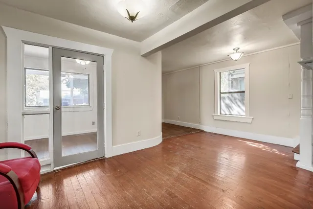 wooden floor in an empty room with a window