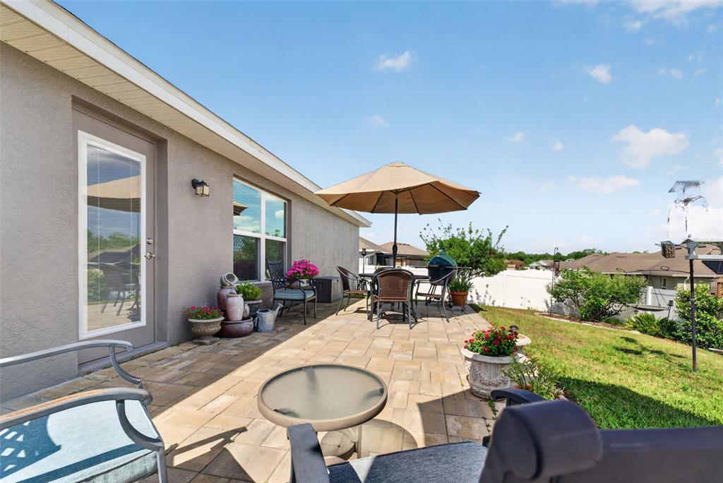 2429 Twin Lake View Road Winter Haven, FL 33881 - Photo 37 of 37 a view of a patio with table and chairs under an umbrella