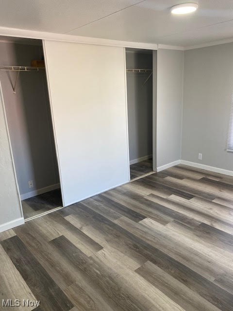 3941 State Road, Unit 48 Cuyahoga Falls, OH 44223 - Photo 7 of 8 Unfurnished bedroom featuring wood finished floors, a closet, baseboards, and ornamental molding