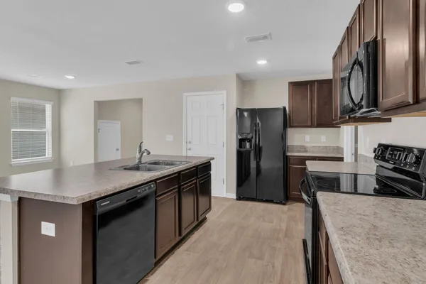 a kitchen with a refrigerator sink and stove