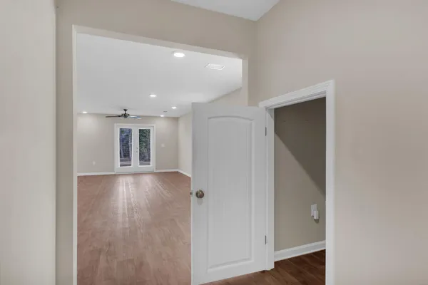 a view of empty room with wooden floor
