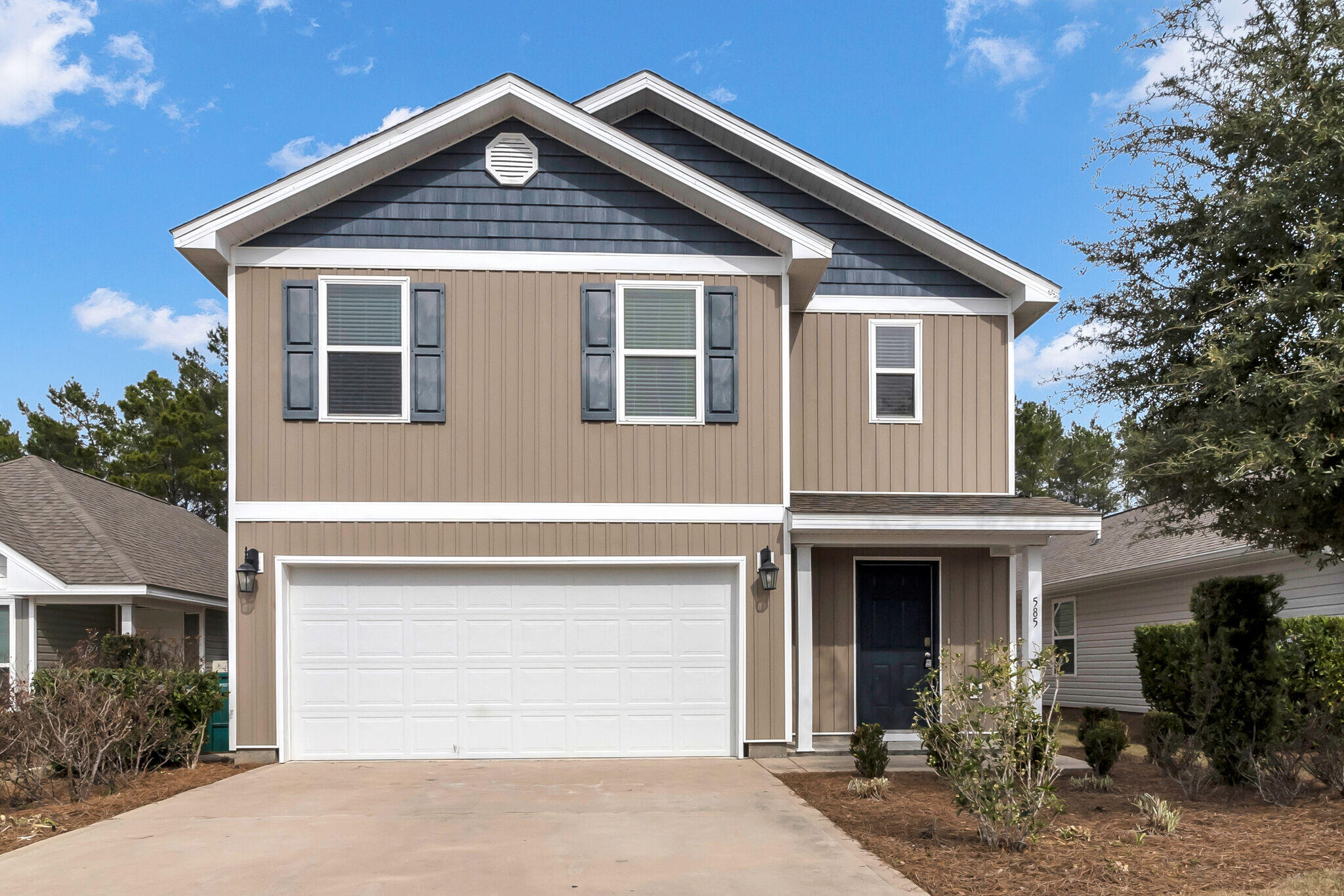 585 Earl Godwin Road Freeport, FL 32439 - Photo 2 of 46 a front view of a house with garden