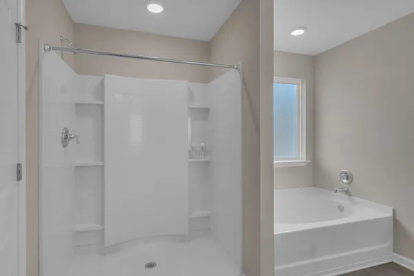 a bathroom with a shower and a tub