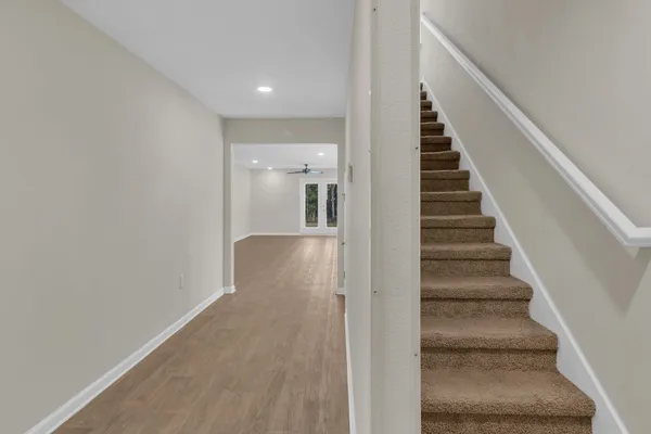 a view of entryway and hall with wooden floor