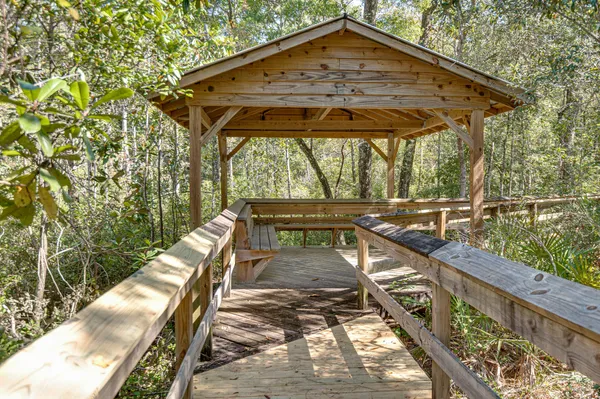 a view of two chairs and a table in the patio
