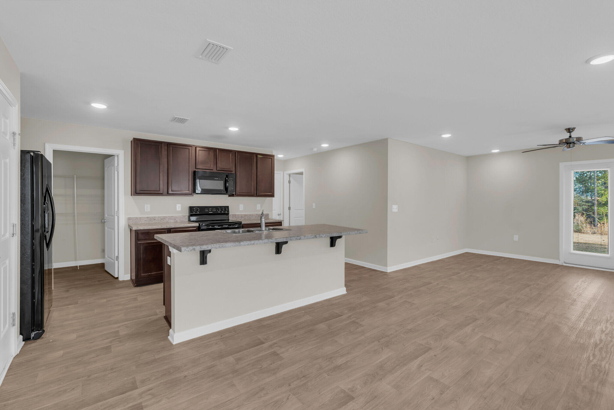 585 Earl Godwin Road Freeport, FL 32439 - Photo 6 of 46 a kitchen with stainless steel appliances granite countertop a refrigerator a sink a stove a microwave and a refrigerator