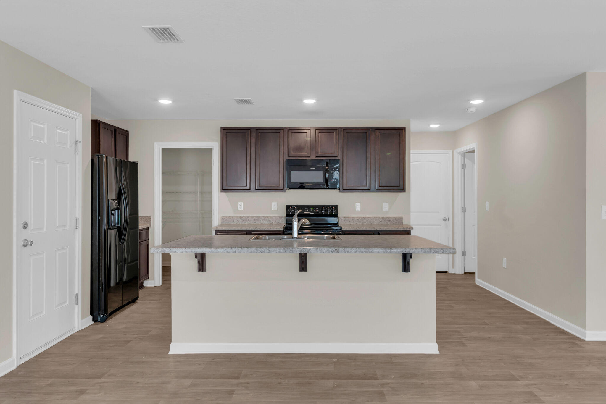 585 Earl Godwin Road Freeport, FL 32439 - Photo 8 of 46 a kitchen with stainless steel appliances granite countertop a sink a stove a refrigerator and a microwave