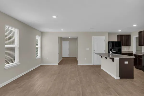 a view of kitchen with stainless steel appliances kitchen island wooden cabinets and window