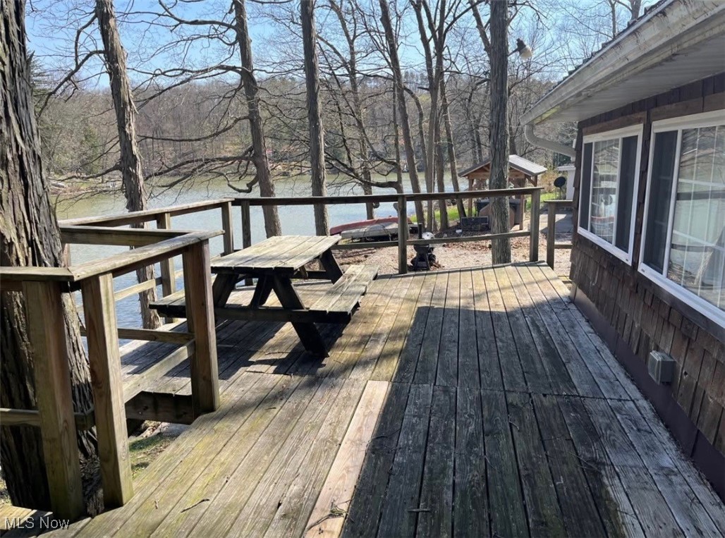 574 Bramble Road Southwest Carrollton, OH 44615 - Photo 4 of 13 Wooden deck featuring a water view and outdoor dining area
