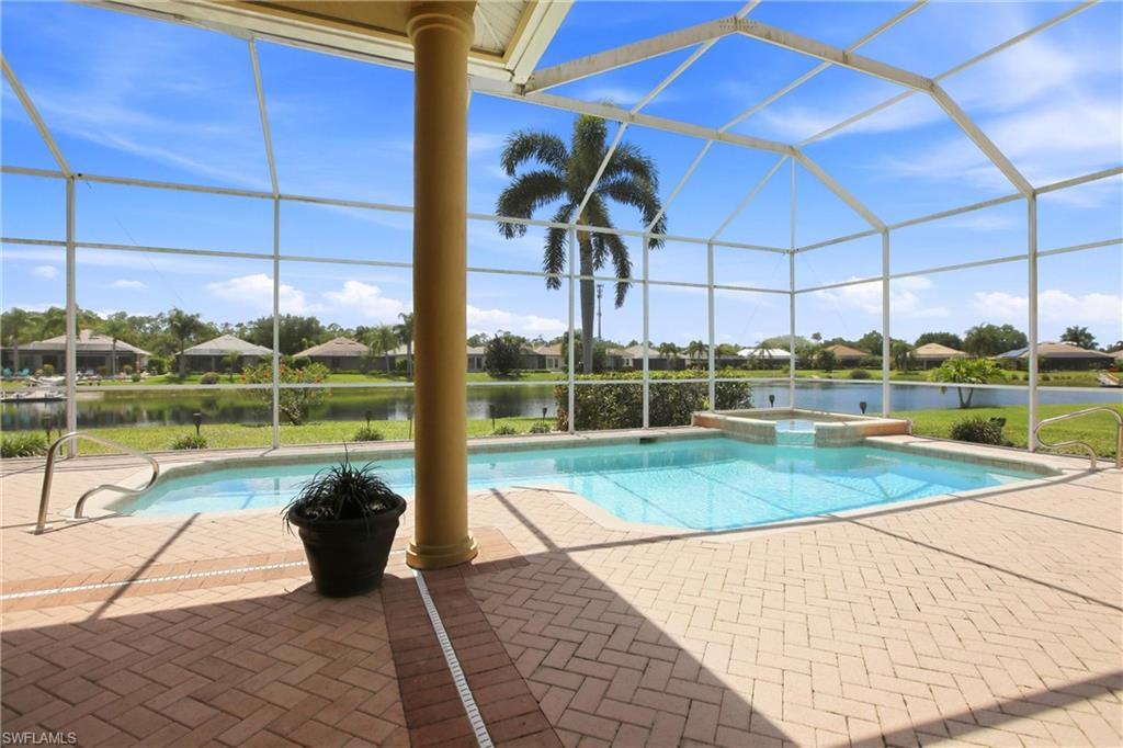 10815 Phoenix Way Naples, FL 34119 - Photo 4 of 40 a view of a swimming pool with a chair