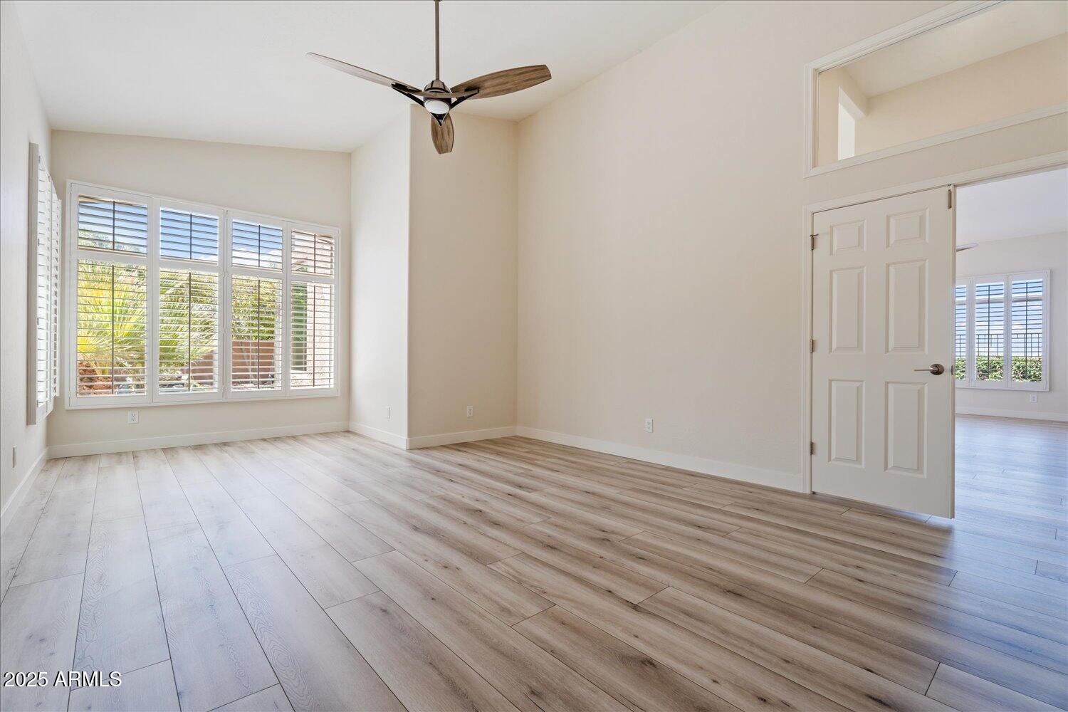 6334 East Viewmont Drive, Unit 9 Mesa, AZ 85215 - Photo 18 of 45 a view of an empty room with wooden floor and a window