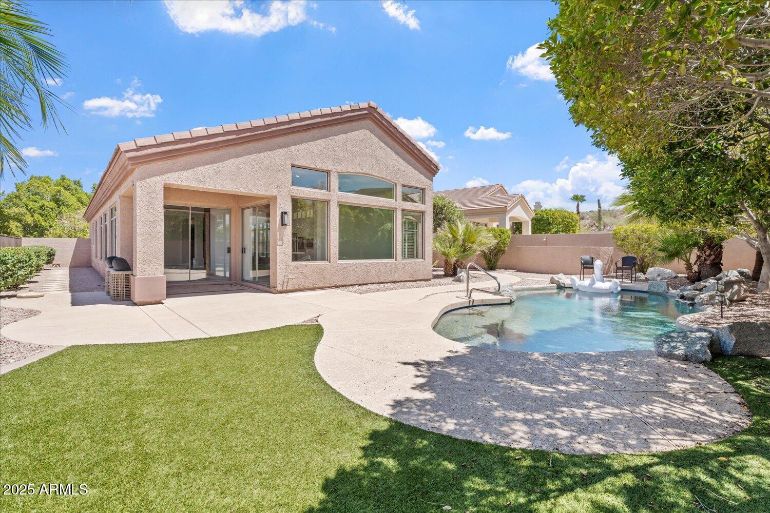 6334 East Viewmont Drive, Unit 9 Mesa, AZ 85215 - Photo 30 of 45 a view of a house with backyard and sitting area