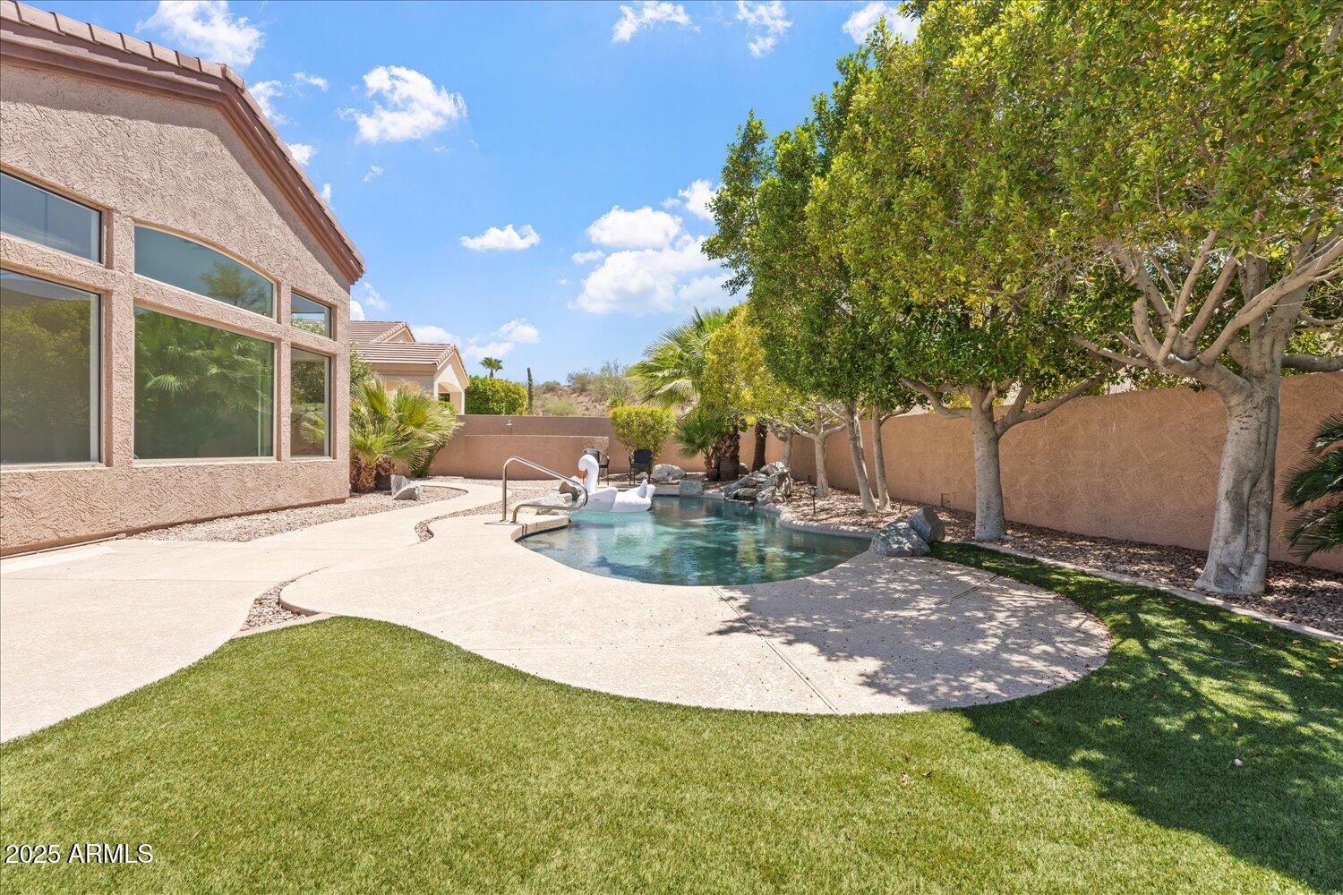 6334 East Viewmont Drive, Unit 9 Mesa, AZ 85215 - Photo 31 of 45 a view of a backyard with plants and a patio