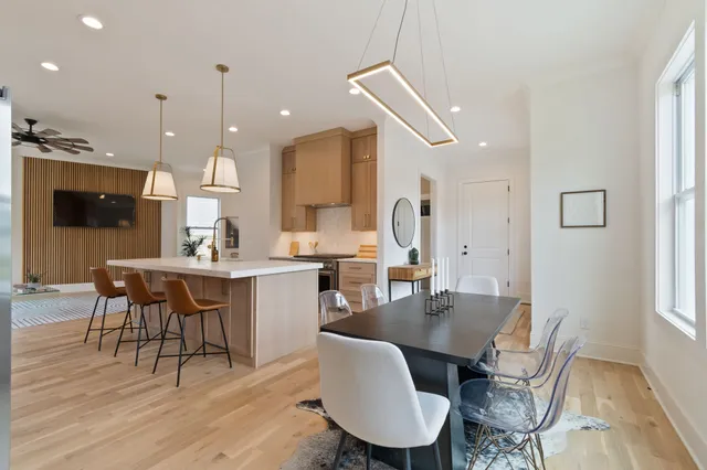 a view of empty room with wooden floor and ceiling fan