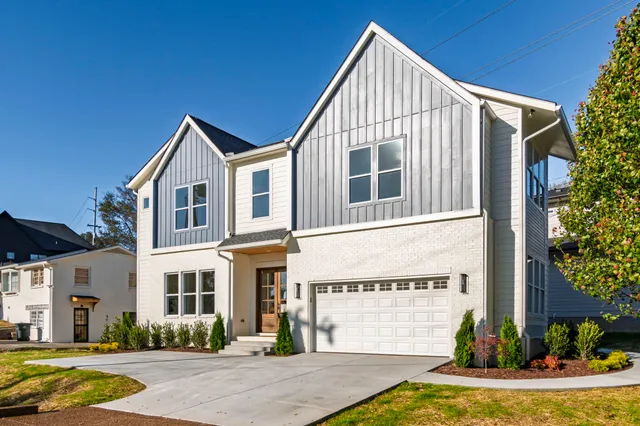 a kitchen with a stove a sink a kitchen island with wooden cabinets and wooden floor