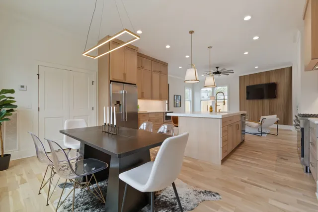a view of a hallway with wooden floor and windows