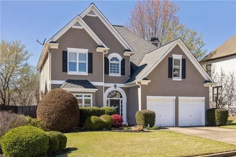 a front view of a house with a yard