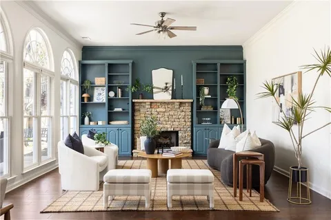 a living room with furniture fireplace and potted plants