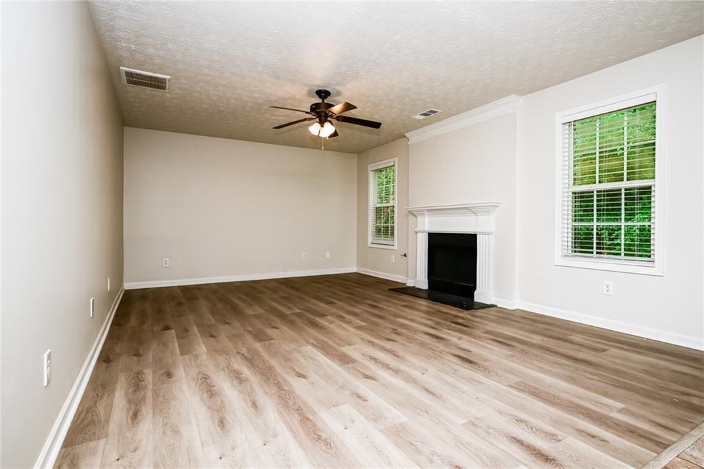 4468 Abram Way Conley, GA 30288 - Photo 21 of 23 a view of empty room with wooden floor and fireplace