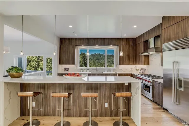 a kitchen with kitchen island granite countertop a stove and a sink