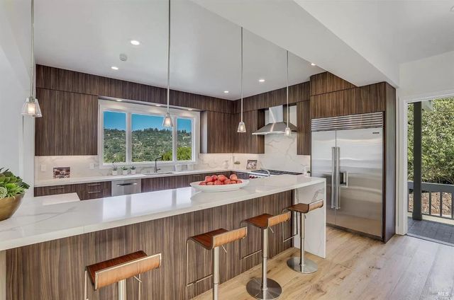 a kitchen that has a lot of counter space and wooden floor