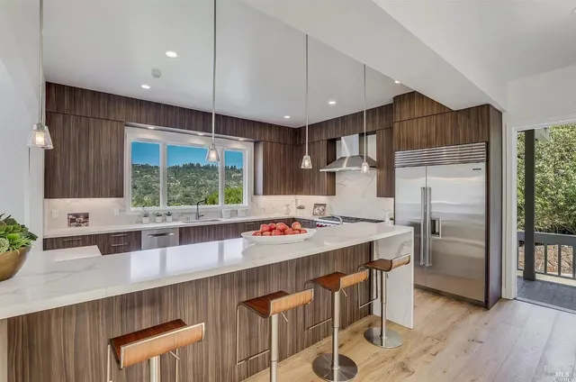 a kitchen that has a lot of counter space and wooden floor