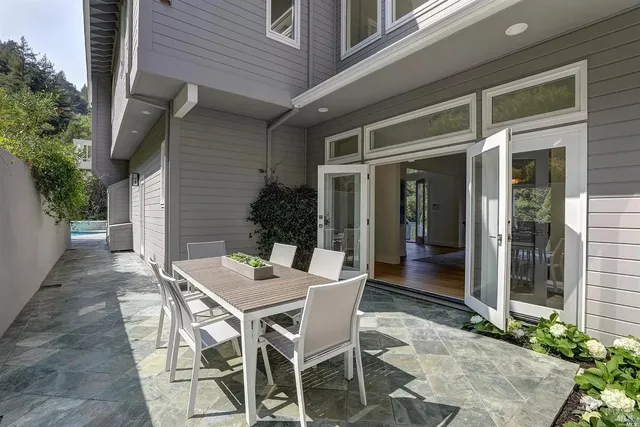 a view of a patio with table and chairs and potted plants